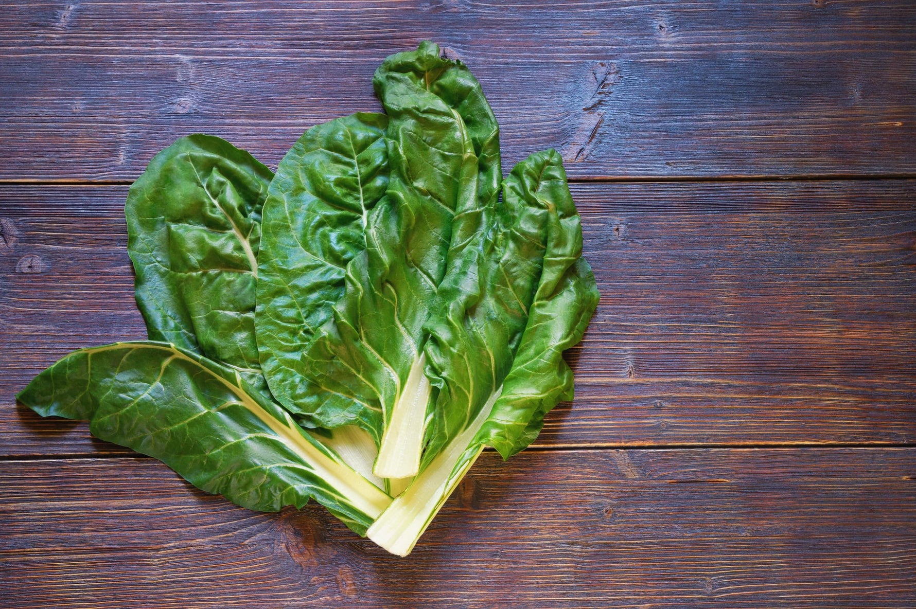 Green leafy vegetable on a wooden surface