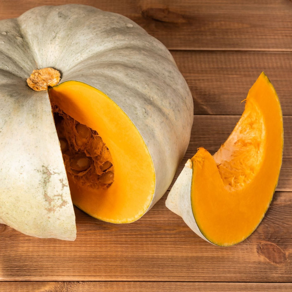 Half-cut pumpkin on a wooden surface
