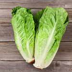Two pieces of green lettuce on a wooden surface